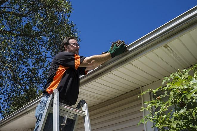 worker repairing a leak in a residential gutter in Davis